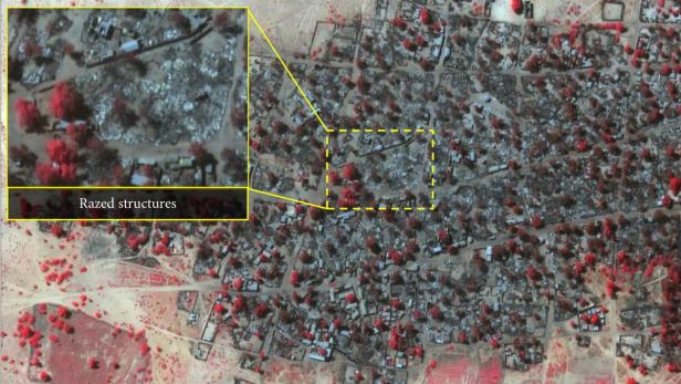 Eine Luftaufnahme von zerstörten Strukturen in einer Ortschaft.