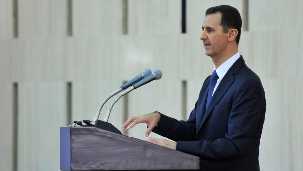epa03813337 A handout photo made available by Syria's Arab News Agency (SANA) shows Syrian President Bashar al-Assad speaking after sharing the Iftar (breakfast) meal with Syrian social figures including political party representatives, politicians, independent figures, Muslim and Christian religious figures, representatives of unions and syndicates, and civil society figures, in Damascus, Syria on 04 August 2013. EPA/SANA HANDOUT EDITORIAL USE ONLY