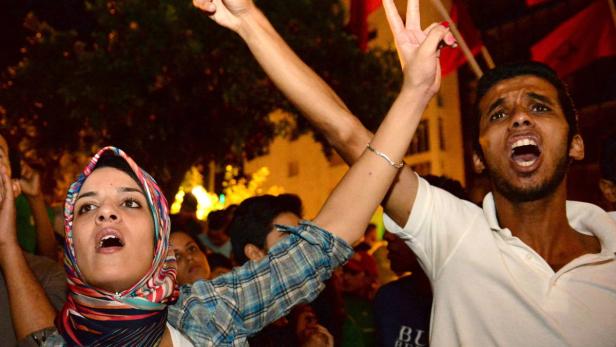 MOROCCO PROTEST epa03813427 Protesters chant slogans during a demonstration in Kenitra, near Rabat, Morocco, late 04 August 2013. The protesters are against the pardon, issued by King Mohamed VI of Morocco, of a Spanish paedophile, Daniel Galvan Fina, who is a convicted rapist of eleven local children. A palace statement issued on 04 August 2013 said that King Mohamed VI has revoked his pardon of Fina. According to media reports Fina has already left the country and is believed to be back in Spain. EPA/Abdelhak Senna