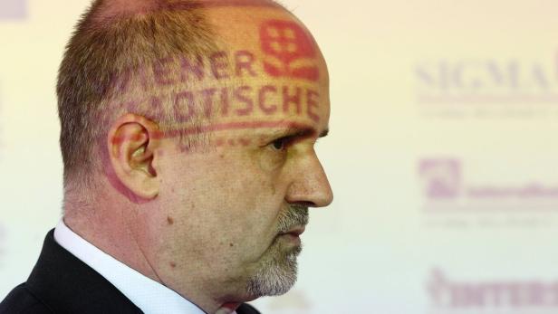 The logo of Vienna Insurance Group is projected on Vienna Insurance Group-CEO Peter Hagen