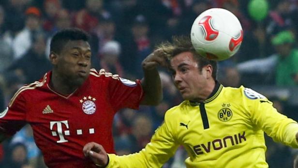 Bayern Munich&#039;s David Alaba (L) and Borussia Dortmund&#039;s Mario Goetze jump for a header during their German soccer cup, DFB Pokal, quarter final match in Munich February 27, 2013. REUTERS/Michael Dalder (GERMANY - Tags: SPORT SOCCER) DFB RULES PROHIBIT USE IN MMS SERVICES VIA HANDHELD DEVICES UNTIL TWO HOURS AFTER A MATCH AND ANY USAGE ON INTERNET OR ONLINE MEDIA SIMULATING VIDEO FOOTAGE DURING THE MATCH