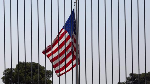 epa03811842 A United States flag flies behind a tall fence at the United States Consulate General building in Jerusalem, Israel, 03 August 2013. The United States has issued a warning to its citizens and travelers following message intercepts by senior Al Qaeda members discussing attacks against American targets, warning to avoid crowded areas such as stations and travel areas, after the US State Department announced plans to close dozens of US Embassies and Consulates in the Middle East and North Africa, including those in Yemen, Egypt, Iraq, Saudi Arabia and Tel Aviv. The US Embassy in Tel Aviv and the Consulate General in Jerusalem are normally closed on both Saturdays and Sundays. EPA/JIM HOLLANDER