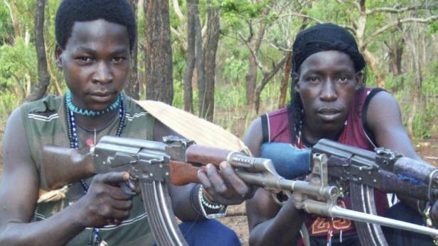 Fighters loyal to the Lord&#039;s Resistance Army (LRA) pose with their rifles inside the forest near River Mbou in the Central African Republic (CAR) in this handout picture dated April 4, 2012.