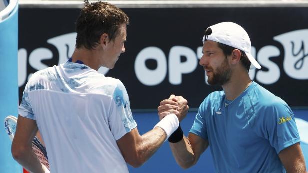 Berdych of Czech Republic shakes hands with Melzer