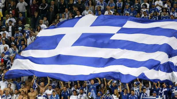 A Greece soccer fans hold a giant national flag during their Euro 2012 quarter-final soccer match against Germany at the PGE Arena in Gdansk, June 22, 2012. REUTERS/Thomas Bohlen (POLAND - Tags: SPORT SOCCER)