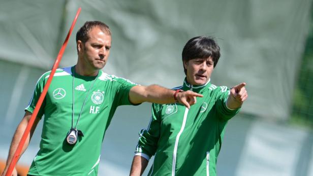 epa03272668 Germany&#039;s head coach Joachim Loew (R) and assistant coach Hansi Flick gesture durin a training session of the German national soccer team at the training ground next to the team hotel Dwor Oliwski in Gdansk, Poland, 19 June 2012. EPA/ANDREAS GEBERT