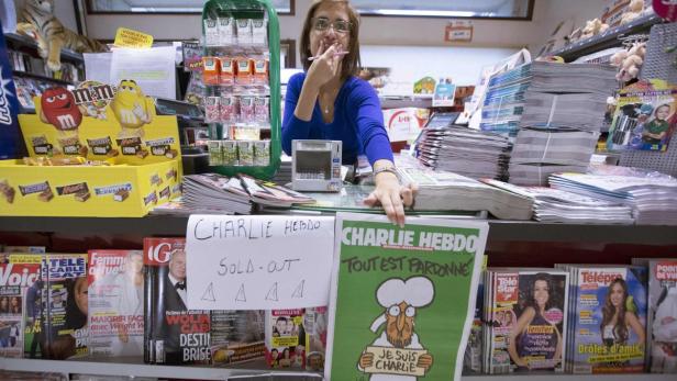 An employee at a bookstore shows her last copy of