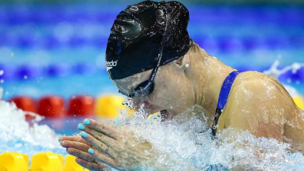 Eine Schwimmerin mit Badekappe und Schwimmbrille schwimmt Brustschwimmen.