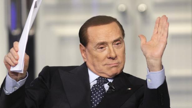 Italy&#039;s former Prime Minister Silvio Berlusconi gestures as he appears as a guest on the RAI television show Porta a Porta (Door to Door) in Rome February 20, 2013. REUTERS/Remo Casilli (ITALY - Tags: POLITICS MEDIA PROFILE TPX IMAGES OF THE DAY)