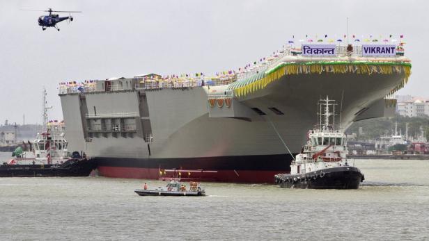 India&#039;s Indigenous Aircraft Carrier P-71 &quot;Vikrant&quot;, built for the Indian Navy, leaves Cochin Shipyard after its launch in the southern Indian city of Kochi August 12, 2013. According to a media release, the 40,000 tonnes aircraft carrier, designed by the Indian Navy (Directorate General of Naval Design) and built by the Cochin Shipyard, is a part of the warship project of the Ministry of Defence. The ship has a length of 262 meters (869ft) and maximum breath of 62 meters (203ft), and will also have two runways for take-off and an angled deck with arrestor wires for landing. REUTERS/Sivaram V (INDIA - Tags: MILITARY MARITIME)