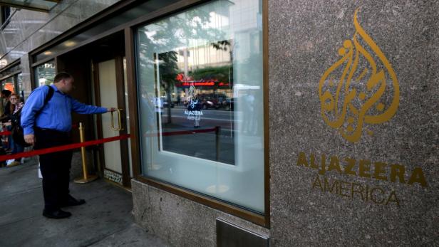 epa03831671 A person enters the new Al Jazeera America television broadcast studio on West 34th Street in New York City, New York, USA, 20 August 2013. Al Jazeera America was scheduled to launch its network in the United States later 20 August, after a decade of trying to gain a firm foothold in the country. Producers and technicians were scrambling to put the final touches on the broadcast from their temporary headquarters at the Hotel New Yorker on 8th Avenue in Manhattan. At 3 pm (1900 GMT) former US President Al Gore was to turn off its Current TV, which served 45 million US homes, and hand over the channel to Al Jazeera, the Qatar-based news organization. With little fanfare and scant advertisements, Al Jazeera America (AJA) was to go live by 4 pm (20:00 GMT) in New York and across the US. EPA/PETER FOLEY