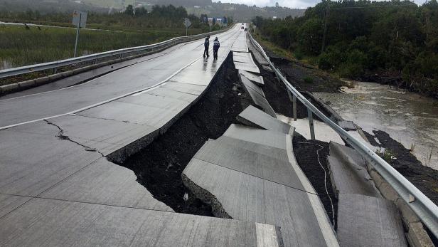 A damaged road is seen after a quake at Tarahuin,