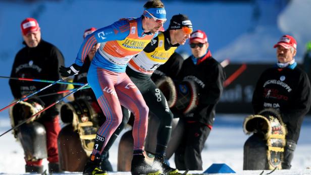 Zwei Langläufer während eines Wettkampfs im Schnee.