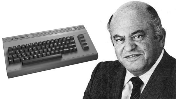 Ein Commodore 64 Computer neben dem Porträt einer Mannes in einem Anzug.