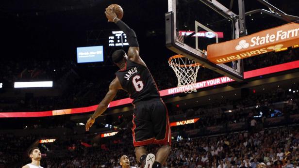 Miami Heat forward LeBron James (6) soars to the basket during their NBA basketball game against the Orlando Magic at the American Airlines Arena in Miami, Florida, March 6, 2013. REUTERS/Robert Sullivan (UNITED STATES - Tags: SPORT BASKETBALL)