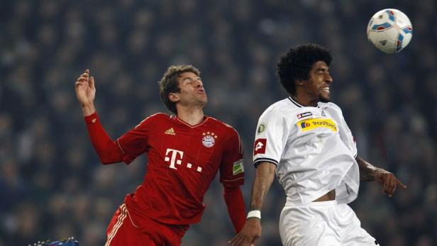 Zwei Fußballspieler kämpfen um einen Ball in der Luft.