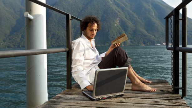 portrait of young man on the dock of Lake