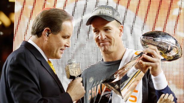 Peyton Manning wird nach dem Super Bowl-Sieg interviewt und hält die Trophäe.