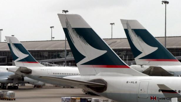 Mehrere Flugzeuge der Fluggesellschaft Cathay Pacific stehen auf einem Rollfeld.