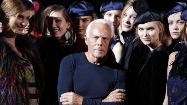 Giorgio Armani posiert mit Models bei einer Modenschau.