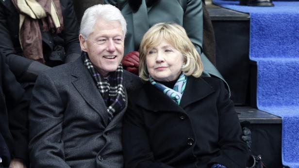 Bill und Hillary Clinton sitzen nebeneinander bei einer Veranstaltung.