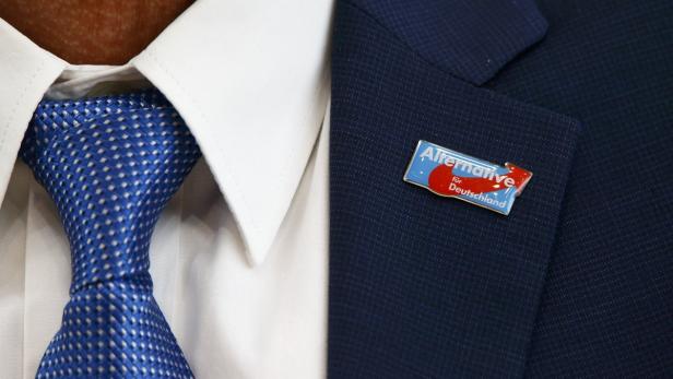 A badge of AfD is seen on the jacket of Junge, can