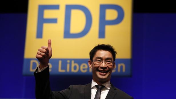 Philipp Roesler, German Economy Minister and leader of the liberal Free Democratic Party (FDP) reacts after been re-elected as party leader during a two-day party convention in Berlin March 9, 2013. REUTERS/Fabrizio Bensch (GERMANY - Tags: POLITICS)