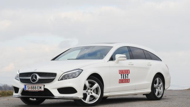Ein weißer Mercedes-Benz mit „Kurier Test Kurier“-Aufklebern auf den Türen.