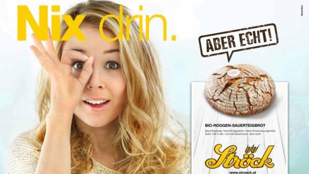 Eine Frau blickt durch einen Kreis, den sie mit ihrer Hand formt, neben einem Brot der Marke Ströck.