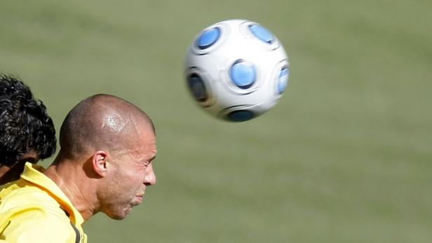 Ein Fußballspieler köpft einen Ball.