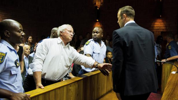 epa03585319 Henke Pistorius (2-L) father of South African paralympic and Olympic sprinter, Oscar Pistorius (R) reaches out to touch his son at the Pretoria magistrates court, South Africa 15 February 2013. Pistorius has been officially charged with murder and his bail application is postponed to the 20th of February. He was arrested 14 February 2013 for allegedly shooting and killing his girlfriend Reeva Steenkamp at his home in the Silverwoods security estate in Pretoria, South Africa. EPA/STR SOUTH AFRICA OUT