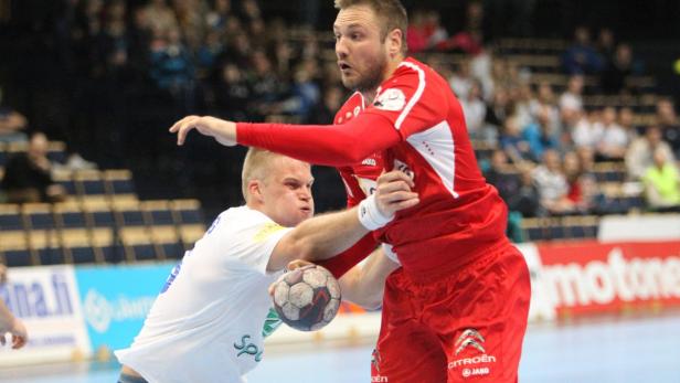 Zwei Handballspieler kämpfen um den Ball.