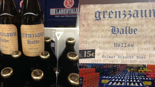 Mehrere Flaschen „Grenzzaun Halbe Helles“ in einem Getränkemarkt.