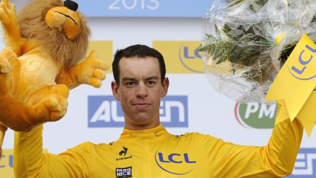epa03616647 Australian rider Richie Porte of the Sky team celebrates on the podium wearing the overall leader&#039;s yellow jersey after the sixth stage of the Paris-Nice cycling race between Manosque and Nice, southern France, 09 March 2013. EPA/YOAN VALAT