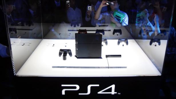 Eine PlayStation 4 Konsole und Zubehör in einer Vitrine.