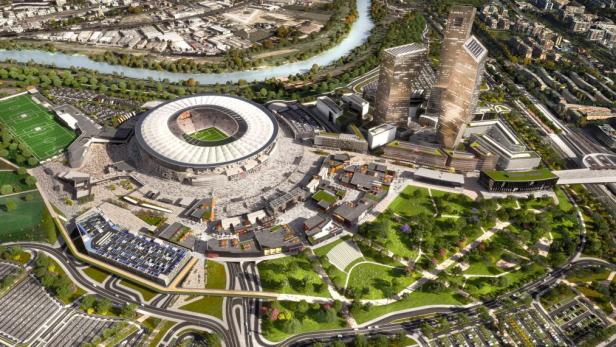 Eine Luftaufnahme eines modernen Stadtstadions mit umliegenden Gebäuden und Grünflächen.