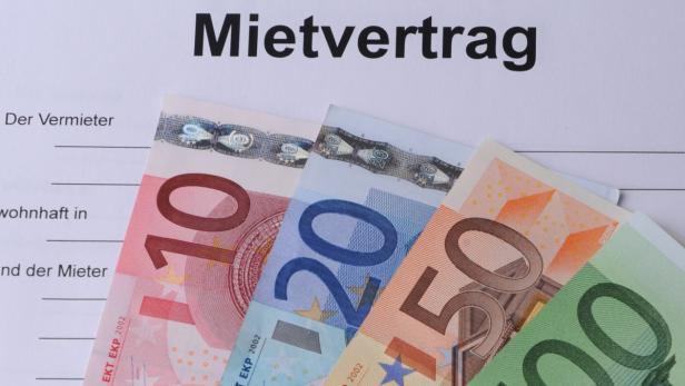 Ein Mietvertrag liegt unter mehreren Euroscheinen.