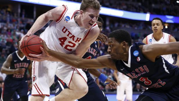 Ein Basketballspieler der Utah Utes kämpft um den Ball gegen einen Spieler von Fresno State.