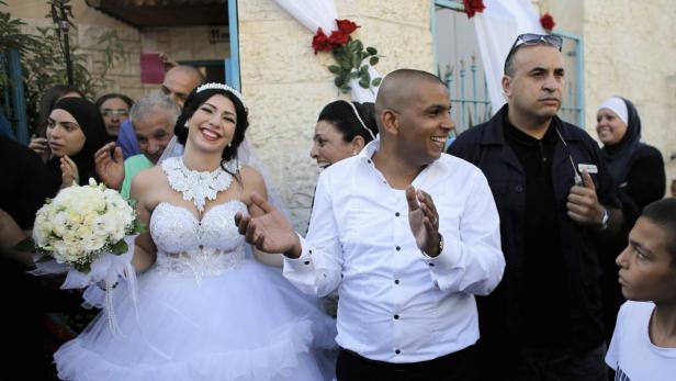 Groom Mahmoud Mansour, 26, and his bride Maral Mal
