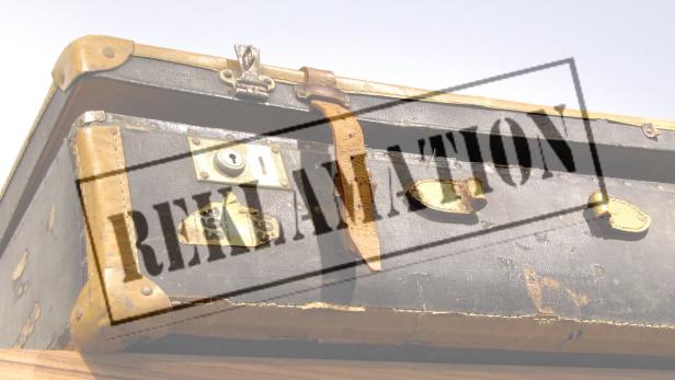 Ein alter, abgenutzter Koffer mit Lederriemen und Metallbeschlägen.