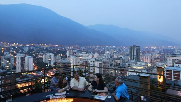 People have a drink at 360, a three-tiered rooftop bar, in Caracas March 11, 2010. Caribbean heat mingles with Andean cool in Caracas, which is nestled against a verdant mountain range, cresting at over 9,000 feet (2,765 meters). Reuters correspondents with local knowledge help visitors get the most of out of a 48-hour visit. Picture taken March 11, 2010. To match Reuters Life! TRAVEL-CARACAS/ REUTERS/Jorge Silva (VENEZUELA - Tags: TRAVEL SOCIETY)