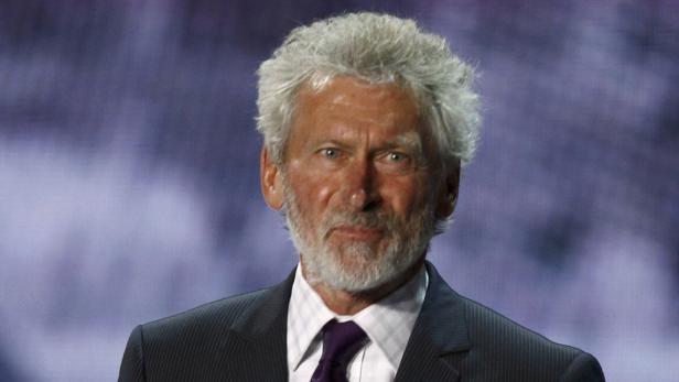 Former German football player Paul Breitner holds a ball during the draw of the Euro 2012 soccer championship at the Palace of Arts in Kiev December 2, 2011. (EURO 2012 DRAW) REUTERS/Kai Pfaffenbach (UKRAINE - Tags: SPORT SOCCER)