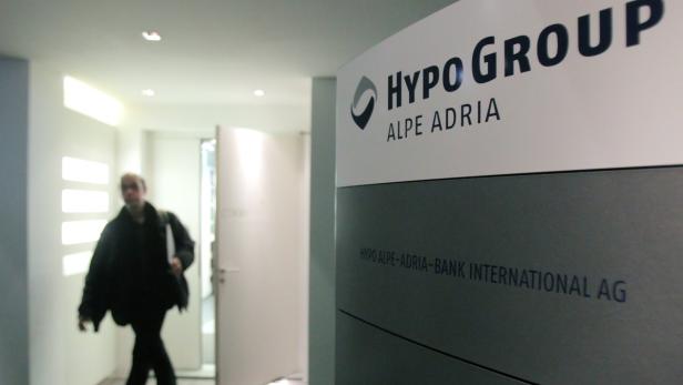 A man leaves the office of nationalised Austrian lender Hypo Alpe Adria in Vienna March 12, 2013. Hypo Alpe Adria boost its total capital ratio to 13.0 percent at the end of 2012, above the level required by regulators even for the end of 2013, it said on Tuesday. REUTERS/Heinz-Peter Bader (AUSTRIA - Tags: BUSINESS)