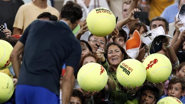 Roger Federer of Switzerland is hounded by autogra
