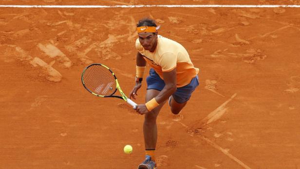 Rafael Nadal spielt Tennis auf einem Sandplatz.