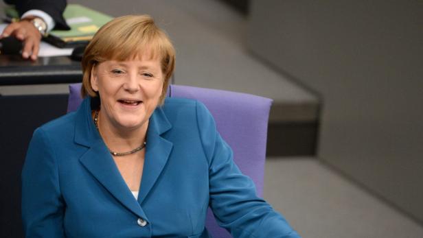 epa03848838 German Chancellor Angela Merkel laughs during the speech of the chairman of the FDP political group at a session of the Bundestag at the Reichstag building in Berlin, Germany, 03 September 2013. Less than three weeks before general elections, the German parliament has met for what is expected to be its last session in the current legislative period. EPA/Soeren Stache