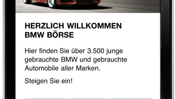 Ein iPhone zeigt die mobile Webseite der BMW Börse mit einem roten BMW im oberen Bereich.