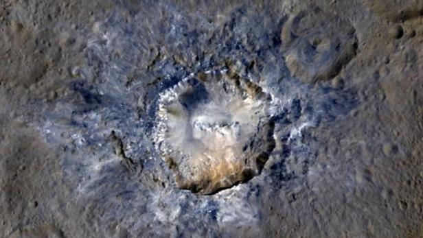 Ein Krater auf einem Himmelskörper, möglicherweise einem Asteroiden oder Mond.