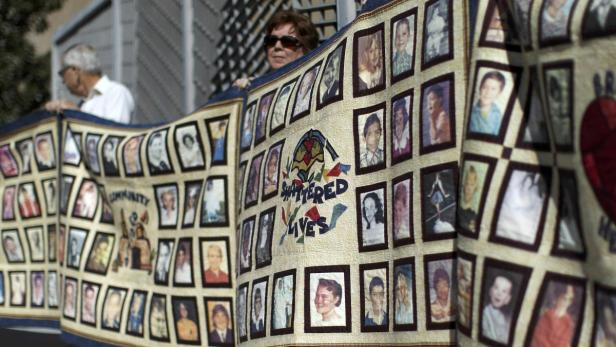People hold quilts at a news conference outside the Cathedral of Our Lady of the Angels for victims of sexual abuse by priests in the Catholic Archdiocese of Los Angeles in Los Angeles, California, in this February 1, 2013 file picture. To match Special Report POPE-SUCCESSION/CHALLENGES REUTERS/David McNew/Files (UNITED STATES - Tags: RELIGION CRIME LAW)