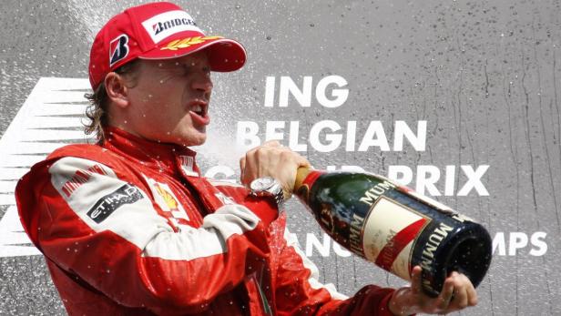 Ferrari Formula One driver Kimi Raikkonen of Finland celebrates after winning the Belgian F1 Grand Prix in Spa Francorchamps August 30, 2009. Raikkonen won the race ahead of Force India Formula One driver Giancarlo Fisichella of Italy who finished second while Red Bull Formula One driver Sebastian Vettel took the third place. REUTERS/Francois Lenoir (BELGIUM SPORT MOTOR RACING)